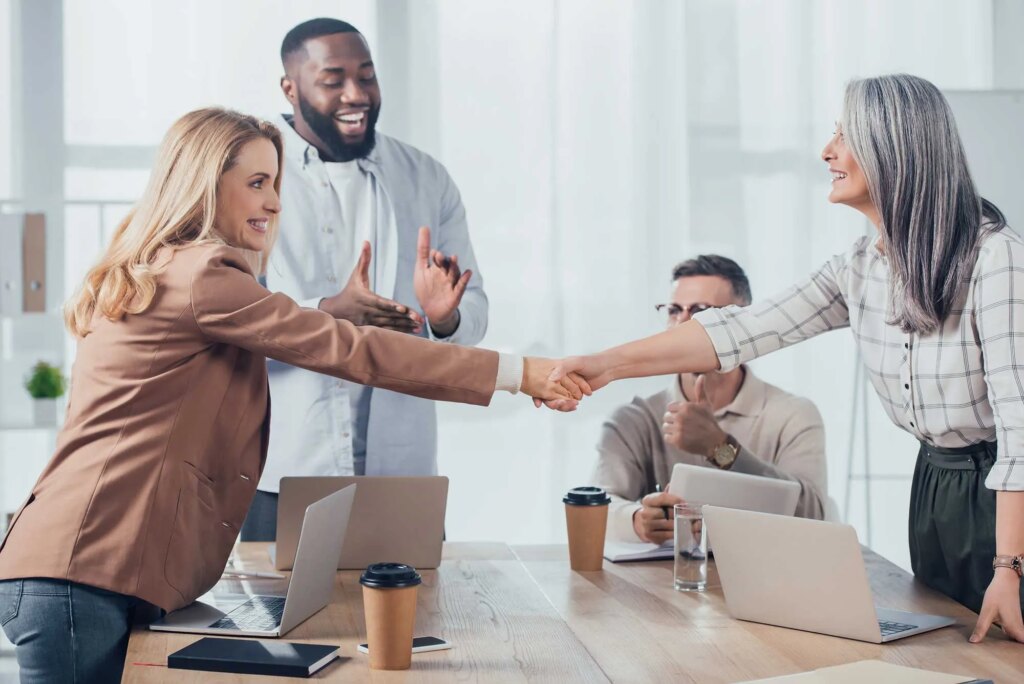 smiling multicultural colleagues shaking hands dur 2022 12 16 19 22 49 utc.jpg